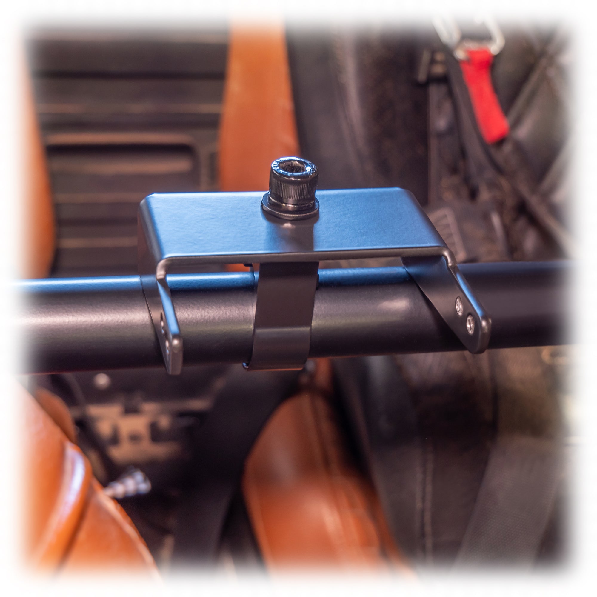 Black powder-coated universal air pumper bracket on roll cage bar
