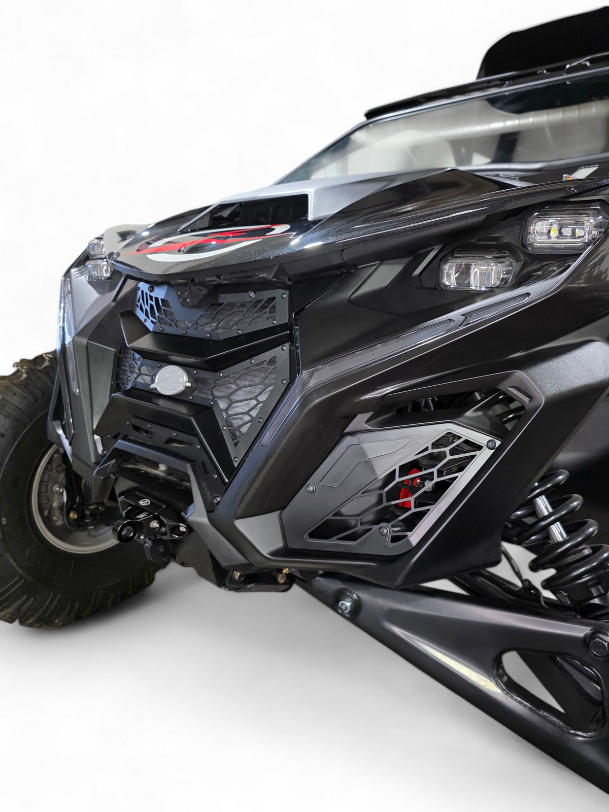 Side angle detail of Volt 3-Piece Grille installed on 2024 Can-Am Maverick R
showing how grille follows natural body contour lines of front fascia