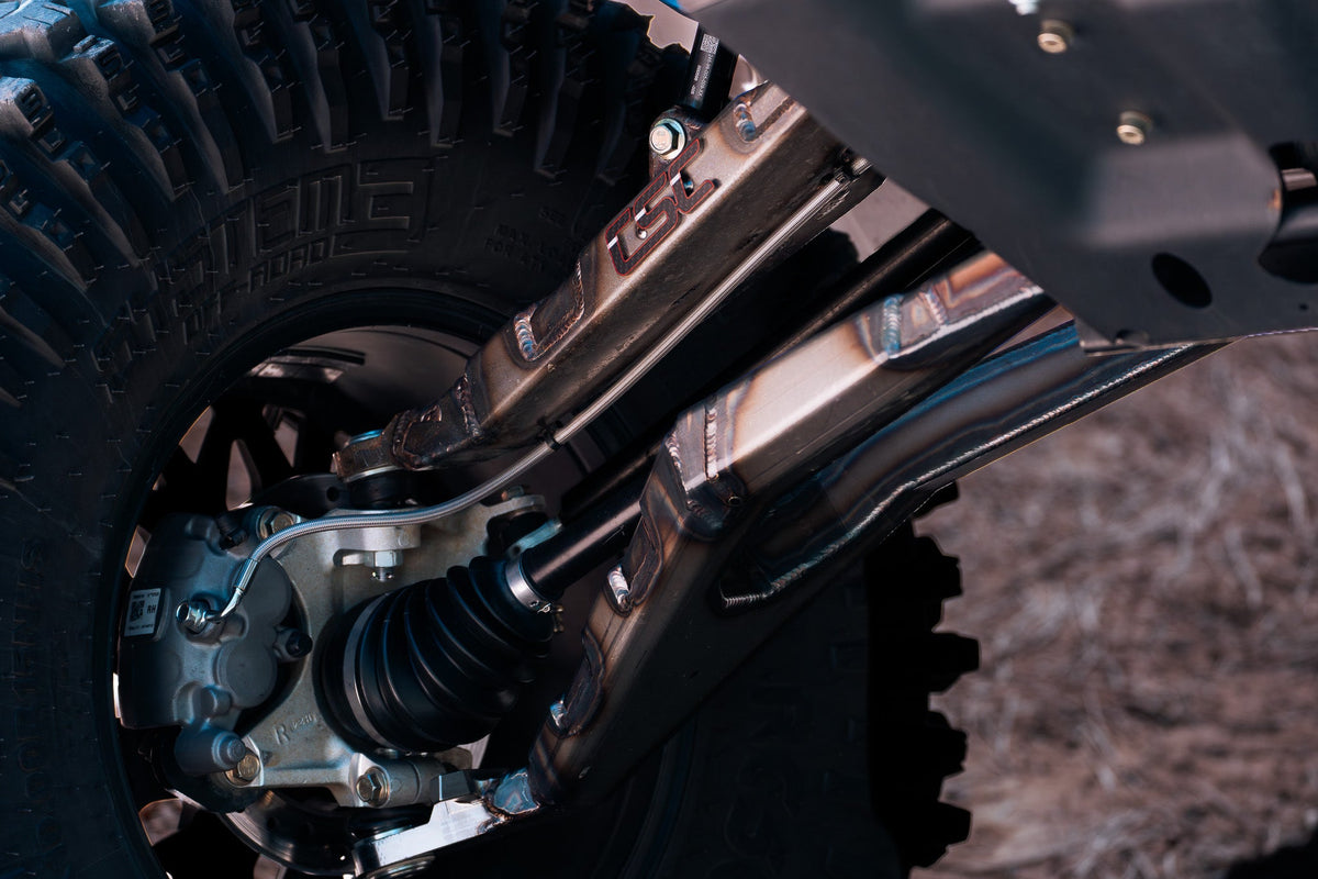 Close-up of a vehicle's suspension system with a blurred background